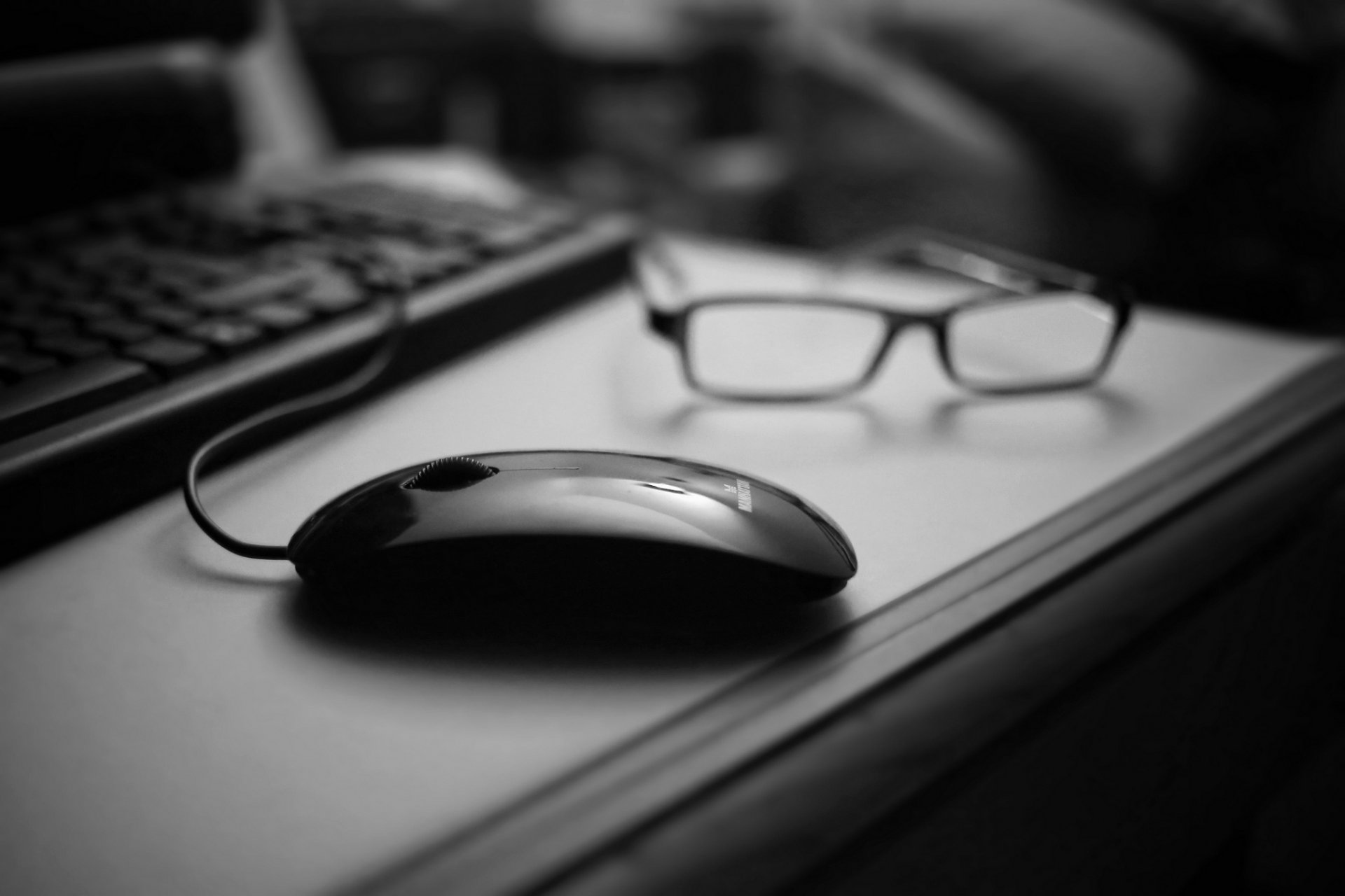 mouse computer black keyboard sunglasses table black and white