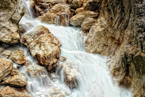 Waterfall among brown rocks