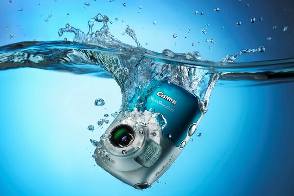 Canon digital camera falls into the water with splashes