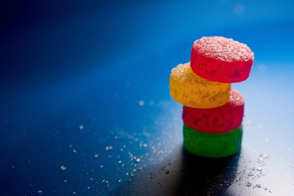 The light falls on a pyramid of colored round candies