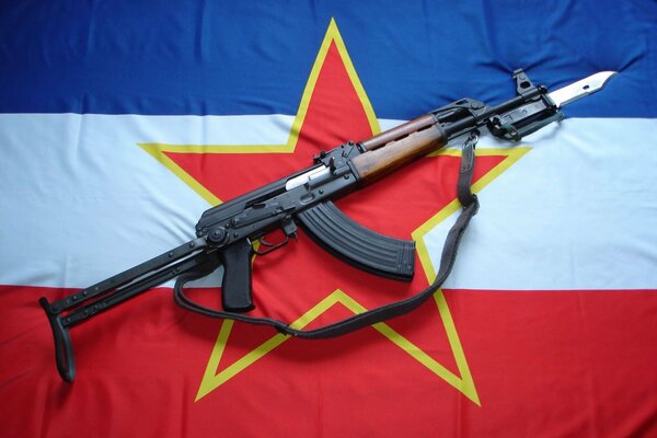 Machine gun on the background of the flag of the Russian Federation with a red star