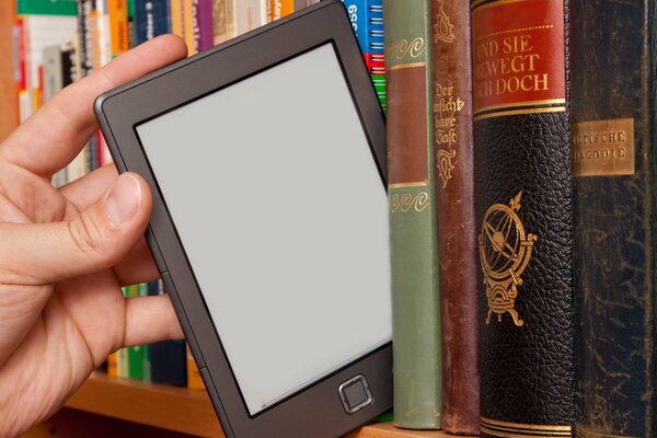 E-book on the shelf with paper