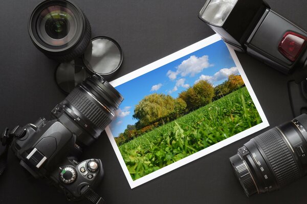 Camera with flash, lenses, lens, photo on the table