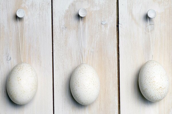 Three eggs on wooden boards