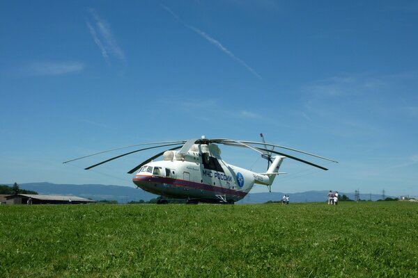 The Mi-26 helicopter of the Ministry of Emergency Situations landed in the mountains on a meadow to rescue people