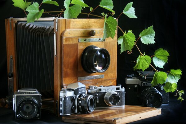 Modern cameras on the background of pinhole cameras