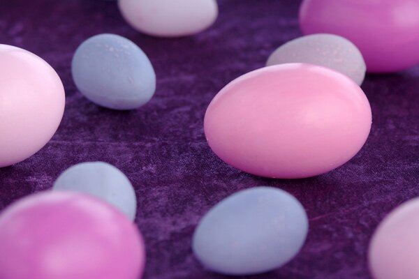 Multicolored eggs on a purple napkin