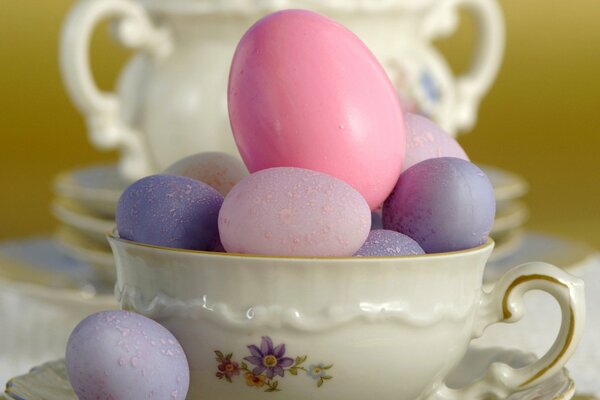 Painted eggs in a porcelain mug