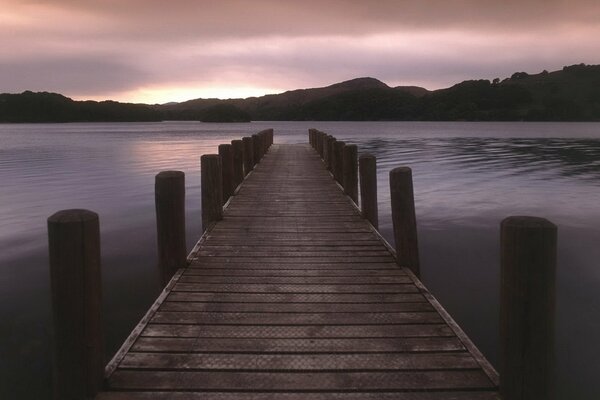 Sunset on a lake with a bridge