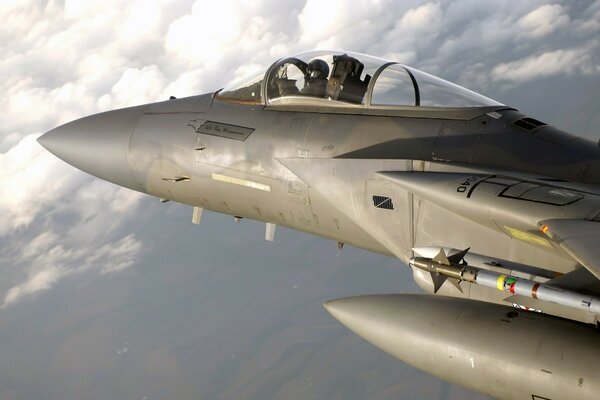 The cockpit of a fighter pilot in the sky above the clouds