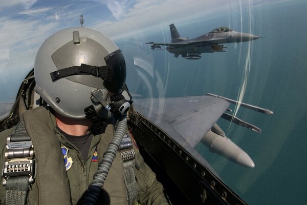 A military plane flies into the clouds with a pilot in the cockpit