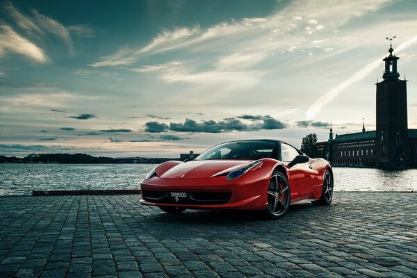 Ferrari 458 on the evening embankment of the river