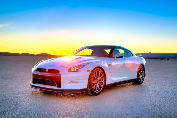 White nissan on sunset background