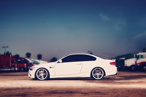 Blue bmw car, on the road against the sky