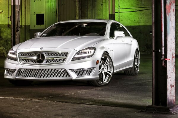 A white Mercedes sports sedan is parked in the tunnel