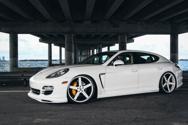 Tuned white Porsche under the bridge