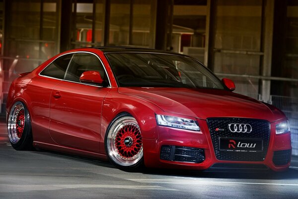 Audi A5 rojo en la carretera de la ciudad