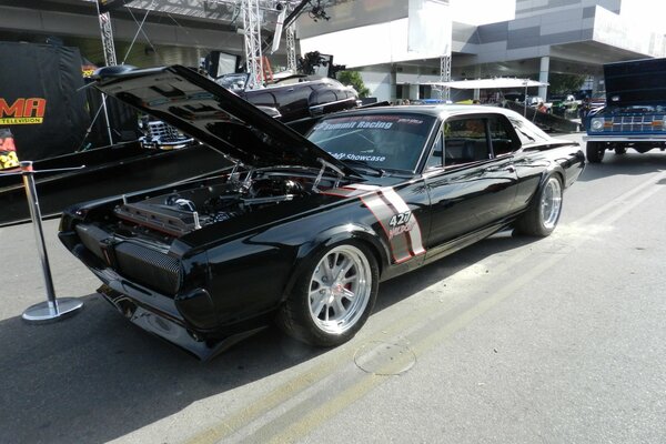 Classic black cougar with open hood