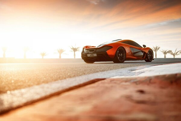 Speed in the desert, side view of a red car