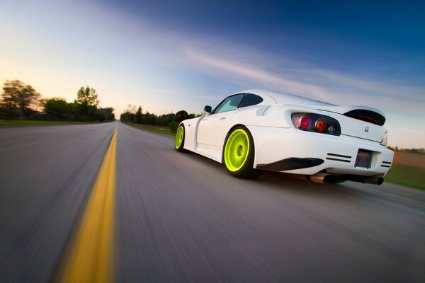 Sporty white Honda with green wheels