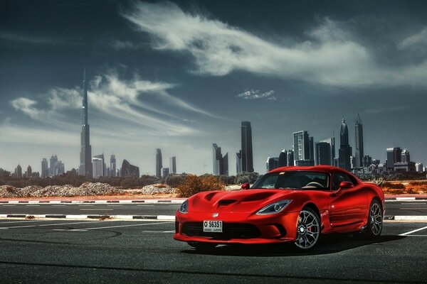 A red car under a blue sky