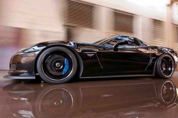 Black supercar in motion on the highway