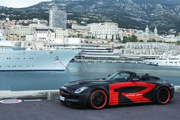 SLS car on the background of a seaport and a boat