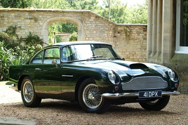 Aston Martin black on the background of ancient buildings