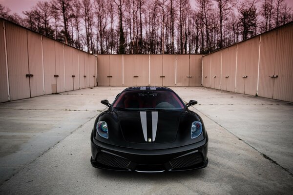 A black car parked in the parking lot