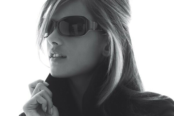 Black and white photo of a girl with glasses