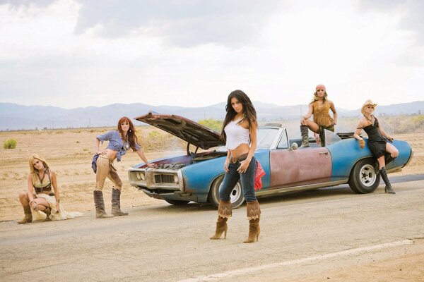 Five girls in the desert near the car