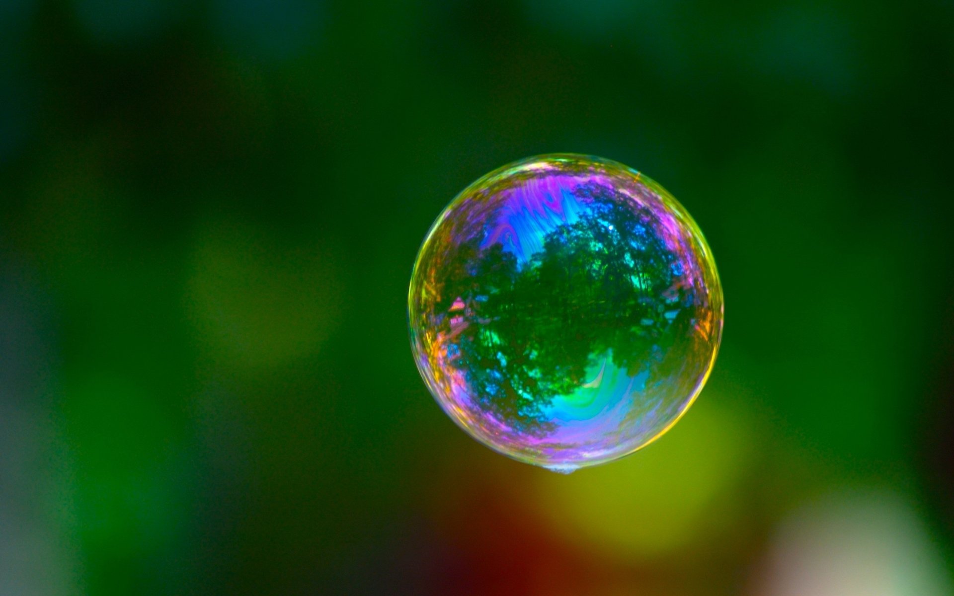 ball bubble the colors of the rainbow greens reflection