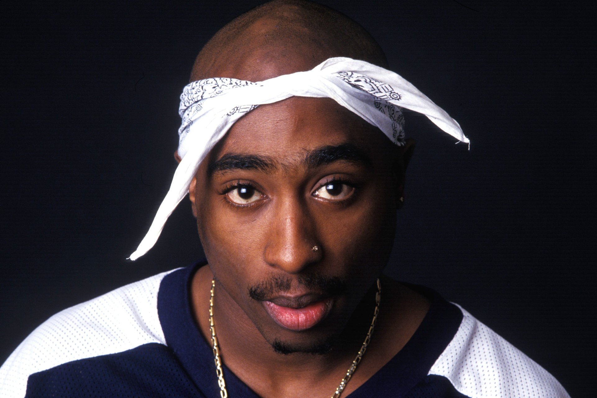 white bandana black guy mediocrity portrait look black eyes face headband chain background piercing mustache unshaven eye