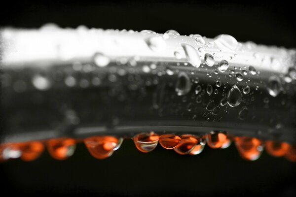 Grey tube with orange droplets