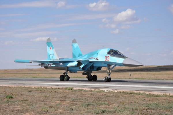 Blue fighter jet on the runway