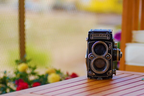 The camera is on a wooden table