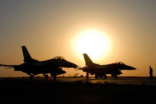 F-16 military aircraft at sunset