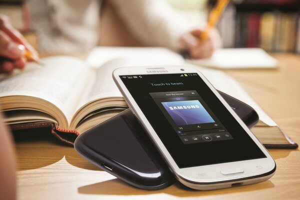 Android Samsung galaxy s3 next to books on the table