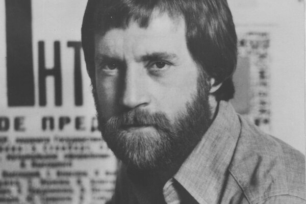 Portrait of the bearded Vladimir Vysotsky on the background of a newspaper