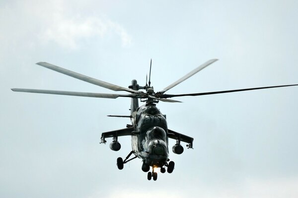 A black military helicopter is flying