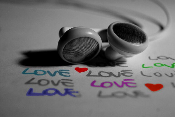 Headphones on a sheet of paper with the inscription love