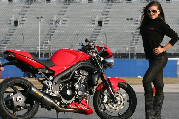 Slender girl and red motorcycle