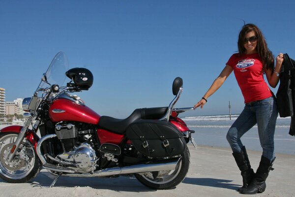 A triumphant girl and a beautiful bike