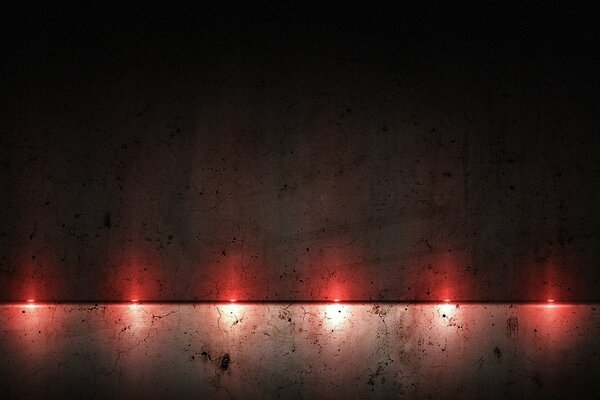 Red light bulbs shine on the wall