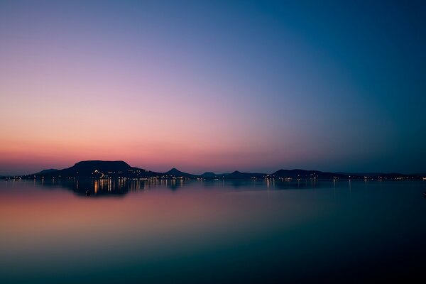 Lights of the mysterious city on the shore