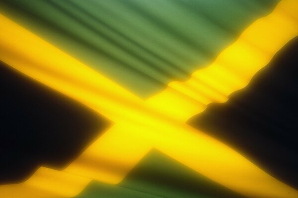 Imagen de la bandera amarilla y verde de Jamaica que se desarrolla en el viento