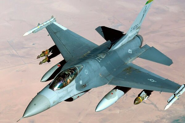 F-16 fighter in flight over the ground