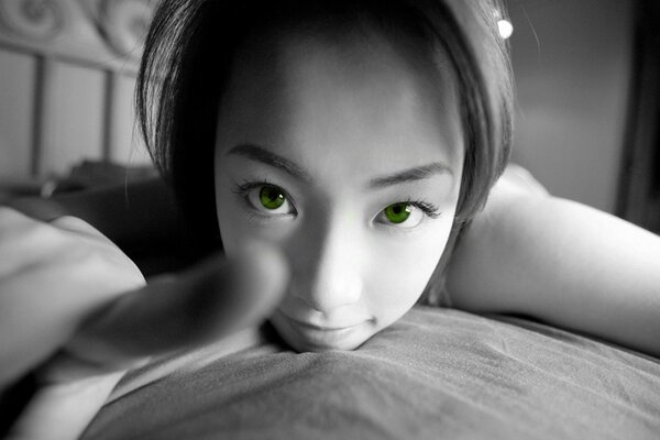 Asian girl with green eyes takes a selfie