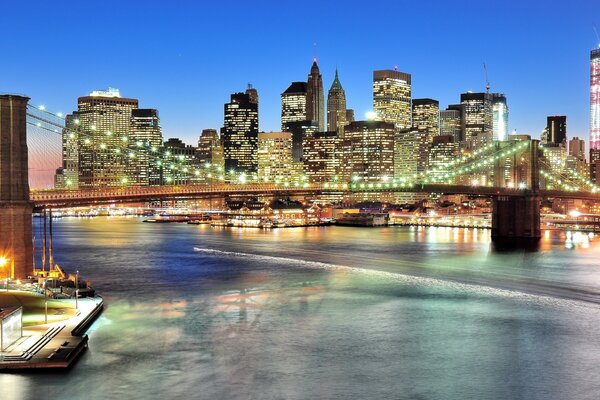 Panorama of Manhattan at night and the Brooklyn Bridge