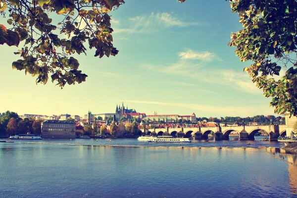 A wide bridge over the water of Prague